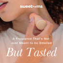 Sweetums Sweet Spot Flavored Fragrance Pineapple Coconut solid perfume stick being applied on the skin.