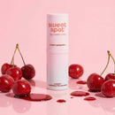 Sweetums Sweet Spot Flavored Fragrance Cherry Bombshell with cherries on pink background.