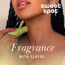 Sweetums Sweet Spot Flavored Fragrance Cherry Bombshell being applied on skin, showcasing its kissable flavor.