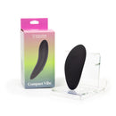 Spectrum Essentials Compact External Vibrator Black in packaging, showcasing its sleek, palm-sized design.