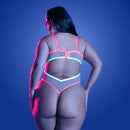 Back view of a curvy model wearing Fantasy Lingerie Glow Full Gauge Teddy Queen Size under vibrant lighting.