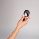 Je Joue Mio V2 Vibrating Cock Ring Black held in a hand against a neutral background.