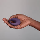 Je Joue Mio V2 Vibrating Cock Ring Purple held in a hand showcasing its design and functionality.