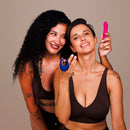 Je Joue Couple's Collection Vibrator Gift Set featuring two women with a blue and pink vibrator, showcasing intimacy and fun.