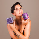 Je Joue Purple Vanilla Massage Candle 160g showcased by a model holding the candle and its packaging.