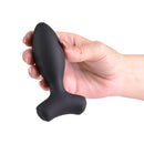 Love Notes Wildflower Vibrating Anal Plug Black held in a hand, showcasing its sleek black silicone design.
