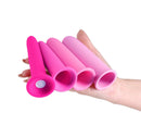 Inya Vibrating Gliders Silicone Vibrator Pink displayed in a hand, showcasing multiple sleek silicone vibrators in shades of pink.