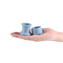 Renegade Buster Silicone Ball Stretcher Gray displayed in a hand showing two-piece silicone design.