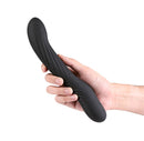 Renegade Wiggle Stick Gyrating Vibrator Black held in hand, featuring a flexible silicone body and ribbed shaft.