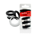 Oxballs Hunkyjunk Jacker 5-Stack Cock Rings Clear Black in compact storage tube with five stretchy rings.