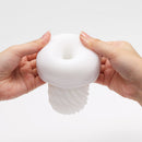 Tenga 3DX Flow Male Masturbator held in hands, showcasing its unique design and features.