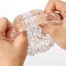 Tenga Geo Glacier Textured Male Masturbator shown being squeezed, showcasing its unique textured design.