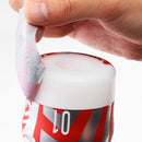 Hand peeling the top label of the Super Tenga Storm Crash Masturbator Cup for access to its features.