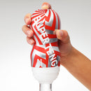 Super Tenga Storm Crash Masturbator Cup held in hand, featuring bold design and texture for enhanced pleasure.