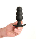Prowler RED Bubble Rechargeable Butt Plug With Remote held in hand, showcasing a smooth, black silicone design.