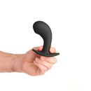 Prowler Red P-spot Rechargeable Plug With Remote held in hand, showcasing its ergonomic design and smooth silicone finish.