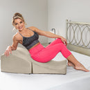 Liberator Flip Ramp Sex Positioning Pillow With Slip Cover Lush Cream shown in use by a smiling woman on a bed.