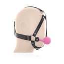 Ple'sur Face Harness Ball Gag Pink displayed on a mannequin head showing adjustable straps and a pink ball gag.