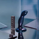 Strap-on-me Fingering and Vibrating Dildo Medium Blue displayed with remote control on reflective background.