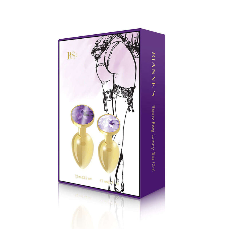 Rianne S 2-Piece Booty Plug Luxury Set Gold featuring elegant gold plugs with purple gemstones in stylish packaging.