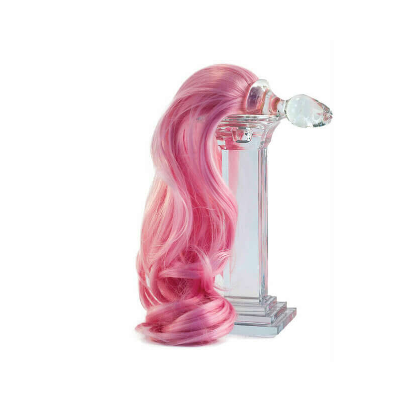 Crystal Delights Minx Pony Tail Plug Baby Pink displayed with long pink hair on a decorative pedestal.