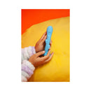 Close-up of hands holding the Cute Little Fuckers Trinity Vibrator Teal on a colorful background.