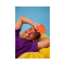 Cute Little Fuckers Starsi Palm Vibrator Coral being held by a smiling person, showcasing playful design and vibrant color.