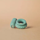 Ohnut Vibrating Penis Ring Jade on a soft surface, showcasing its ergonomic design and powerful motor for enhanced pleasure.
