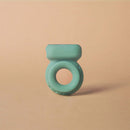 Ohnut Vibrating Penis Ring Jade on a textured surface, showcasing its soft and flexible design for enhanced intimacy.