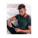 A man sitting on a couch using Eye of Love Matchmaker Black Diamond Attract Her Pheromone 10 ml fragrance.