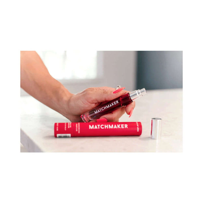 Eye of Love Matchmaker Red Diamond Attract Him Pheromone Parfum 10 ml in hand with packaging on table.