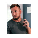 Man holding Eye of Love Matchmaker Black Diamond Attract Them Pheromone 10 ml fragrance in stylish setting.