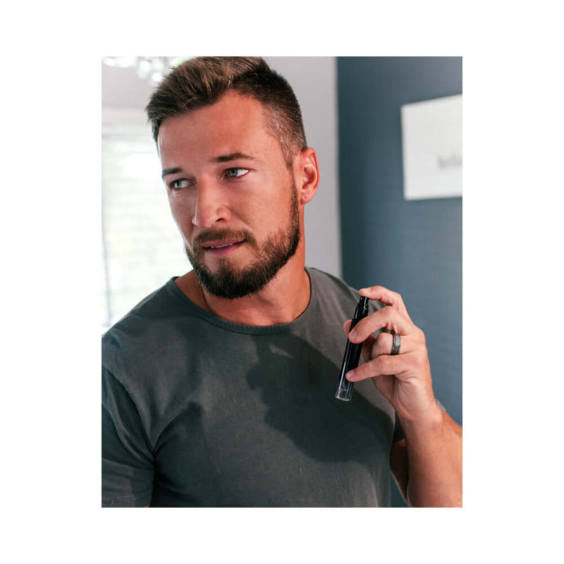 Man holding Eye of Love Matchmaker Black Diamond Attract Them Pheromone 10 ml fragrance in stylish setting.