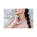 Eye of Love Matchmaker Red Diamond Attract Them Parfum 10 ml in hand of a woman against a brick background.