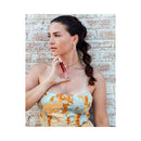 Model holding Eye of Love Matchmaker Red Diamond Attract Them Parfum 10 ml, showcasing its elegant design.