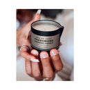 Eye of Love After Dark Attract Him Pheromone Massage Candle held in hands, showcasing its rich design.