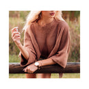 Woman applying Eye Of Love One Love Attract Him Pheromone Parfum 10 Ml while wearing a cozy brown sweater.