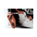 Woman holding Eye Of Love One Love Attract Him Pheromone Parfum 10 Ml in a sparkling outfit, showcasing the product.