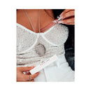 Eye Of Love Unscented Female Pheromone Parfum 10 mL held by a person wearing a sparkling outfit.