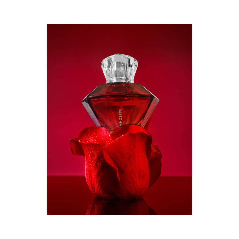 Eye of Love Matchmaker Red Diamond Attract Him Parfum 1 Oz bottle on red rose background.