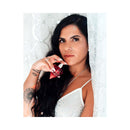 Eye of Love Matchmaker Red Diamond Attract Her Parfum 1 Oz held by a woman with long hair and tattoos.