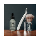 Eye of Love Attract Her Natural Pheromone Beard Oil 1 Oz with razor and shaving brush on wooden surface.