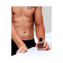Eye of Love Romantic Attract Her Pheromone Parfum 1.67 Oz held by a muscular man with a confident look.