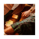 Couple playing with VUSH Curiosity Cues 50 Cards on a vibrant rug, fostering connection and conversation.