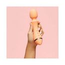 Person holding VUSH Majesty 2 Wand Vibrator against a pink background, showcasing its sleek design.