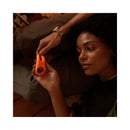 A person holding the VUSH Orb Pleasure Ring Vibrator, showcasing its sleek design and comfortable use.