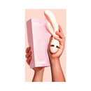 VUSH Muse Rabbit Vibrator held in hand with packaging, showcasing its design and dual stimulation features.