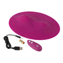 VibePad Hands Free External Vibrator in pink color, includes USB charging cable and remote for hands-free stimulation.