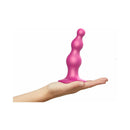 Strap-on-me Dildo Plug Beads Small Raspberry held in a hand, showcasing its beaded design and ergonomic shape.