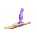 Strap-on-me Dildo Plug Curvy Small Purple held in hand, showcasing its unique body-hugging design and vibrant color.
